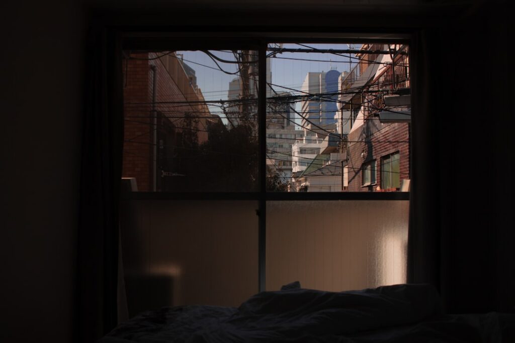 A serene bedroom scene at night with a person peacefully sleeping On a nearby nightstand there s a glass of warm milk a