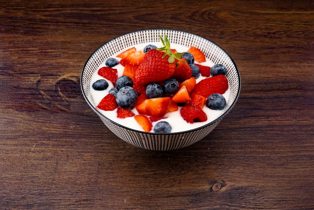 A vibrant appetizing breakfast bowl with Greek yogurt topped with colorful berries nuts and chia seeds