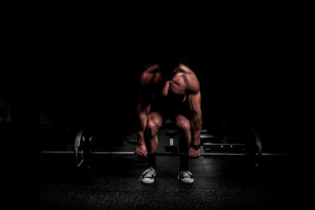 A person performing a bicep curl with dumbbells focusing on proper form in a gym setting