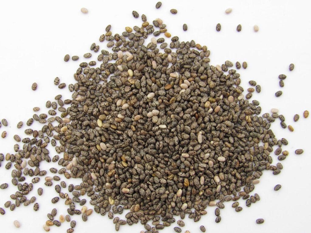 Various ingredients for a healthy beauty drink laid out on a clean surface including chia seeds a collagen supplement co