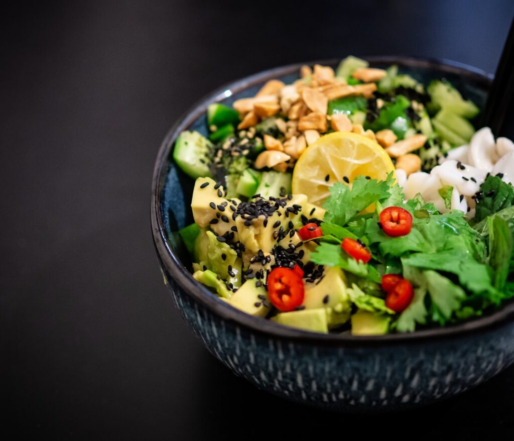 A vibrant creamy avocado and cucumber salad served in a bowl garnished with fresh herbs It looks fresh wholesome and inv