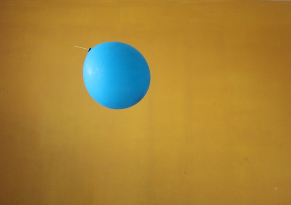 Two identical balls suspended at the same height Ball A is attached to a stretched spring while Ball B is attached to a