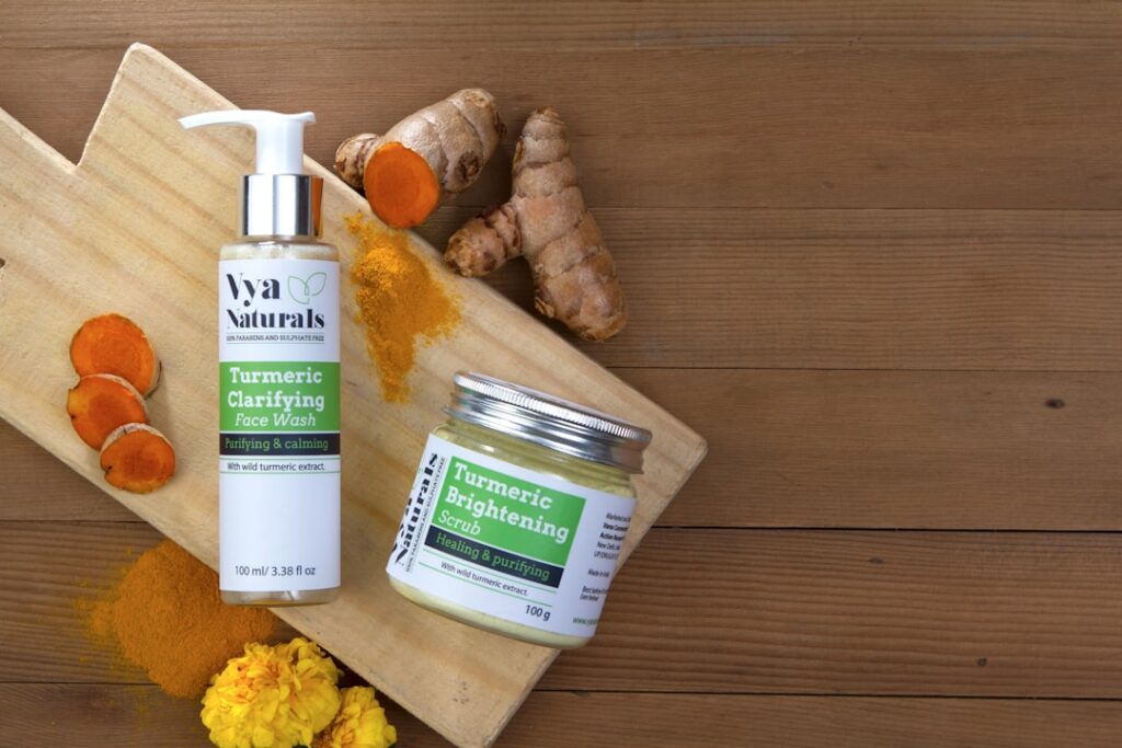 A close-up of natural ingredients like aloe vera vitamin E capsules and a small bottle of nourishing oil placed next to 