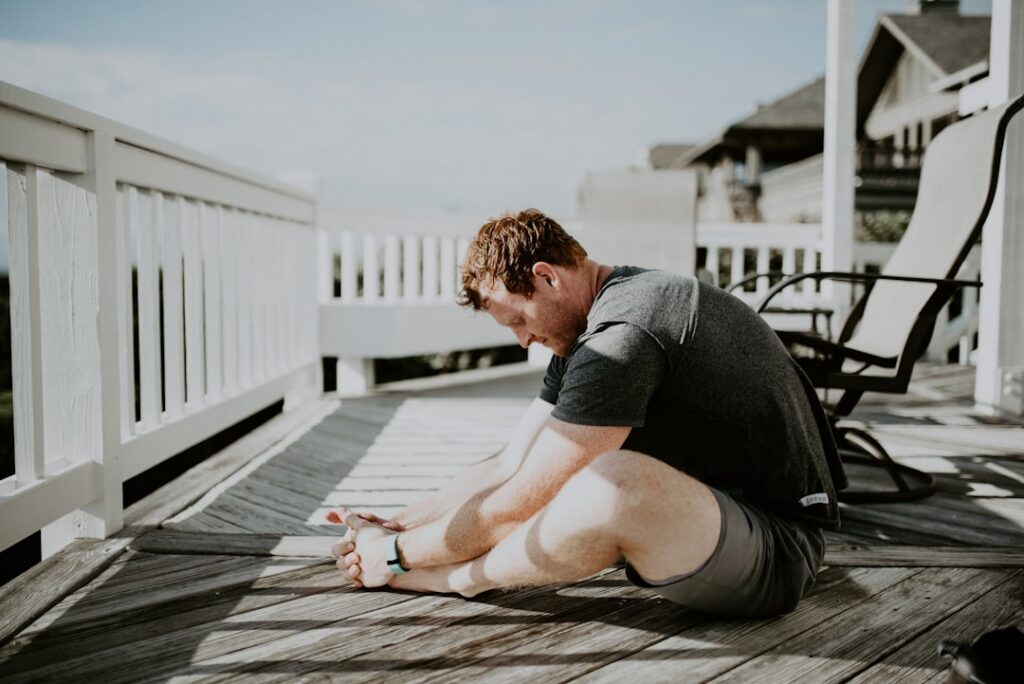 A person gracefully performing a gentle stretching or mobility exercise possibly a hip circle or dynamic arm swing in a 