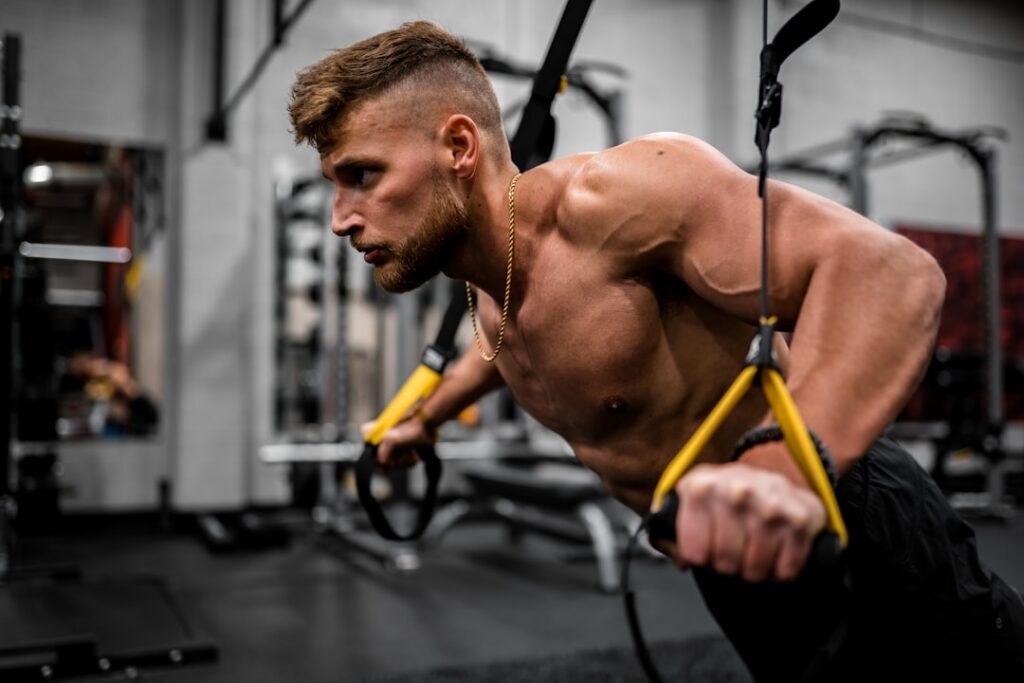 A person performing cable flyes in a gym showing proper form and muscle contraction