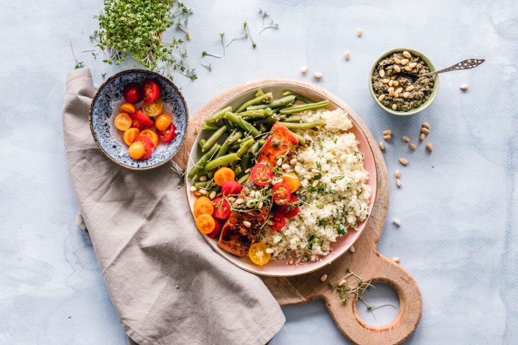 A vibrant spread of perfectly cooked vegan dishes including crispy tofu colorful roasted vegetables and a bowl of quinoa