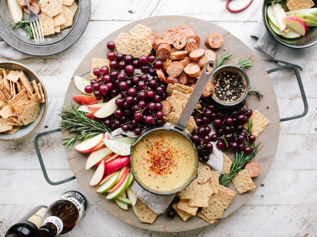 A vibrant flat lay of various healthy snack components such as sliced apples a small bowl of peanut butter a handful of 