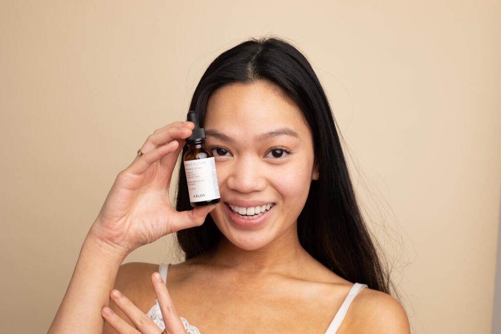 A person gently applying a serum to their face demonstrating proper skincare application