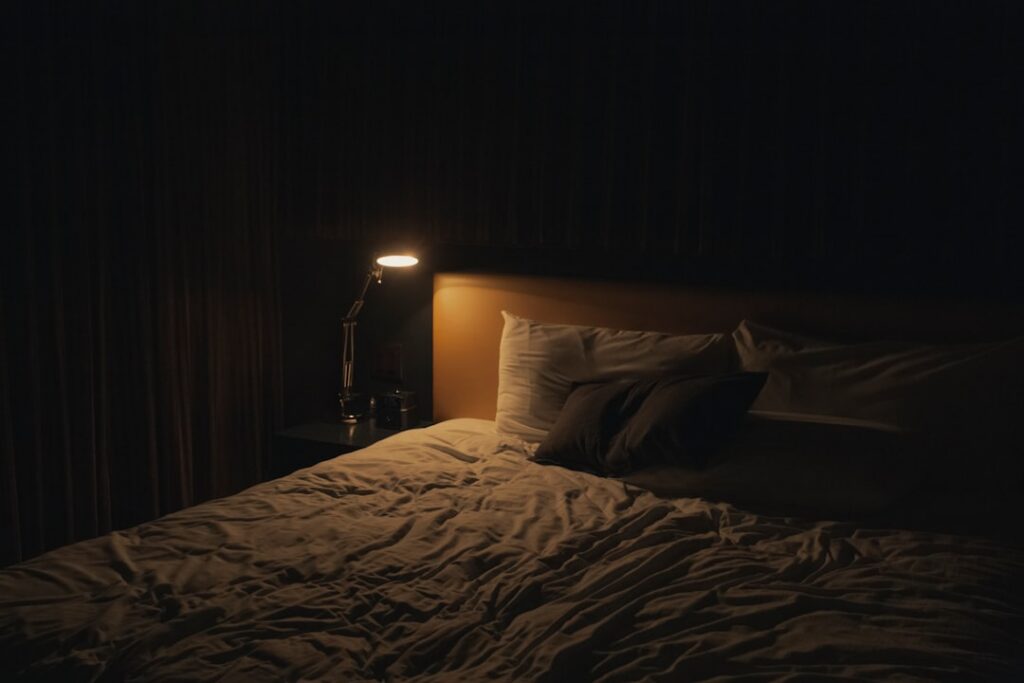 A person peacefully sleeping in a cozy bed with soft lighting