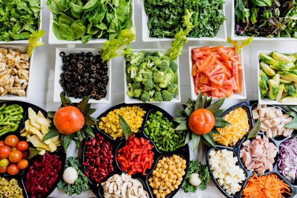 A vibrant assortment of fresh folate-rich foods like spinach avocado lentils broccoli and citrus fruits arranged attract