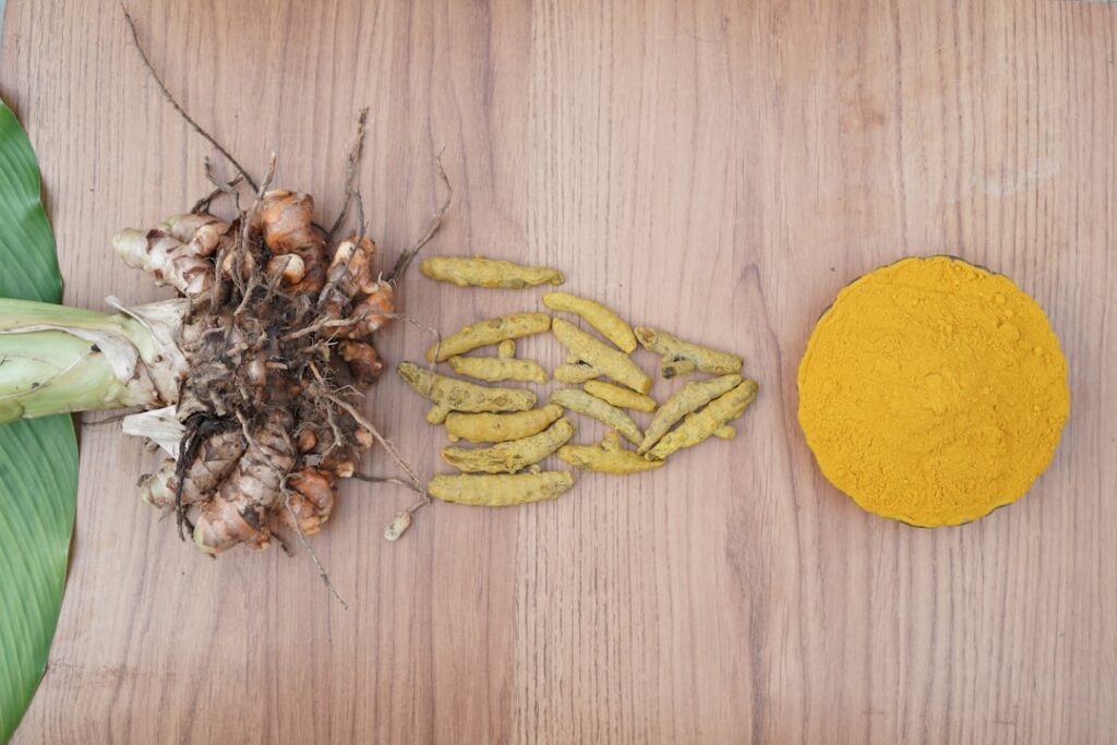 A close-up of a small jar of Vaseline mixed with turmeric powder showing its bright yellow color and smooth texture symb