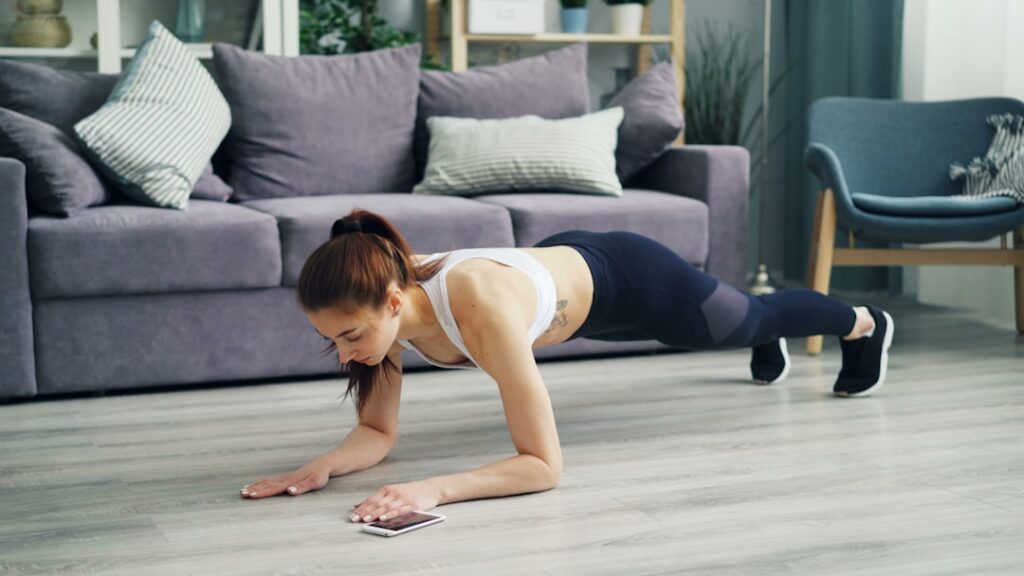 A person holding a perfect side plank position on a yoga mat with a neutral spine and hips lifted