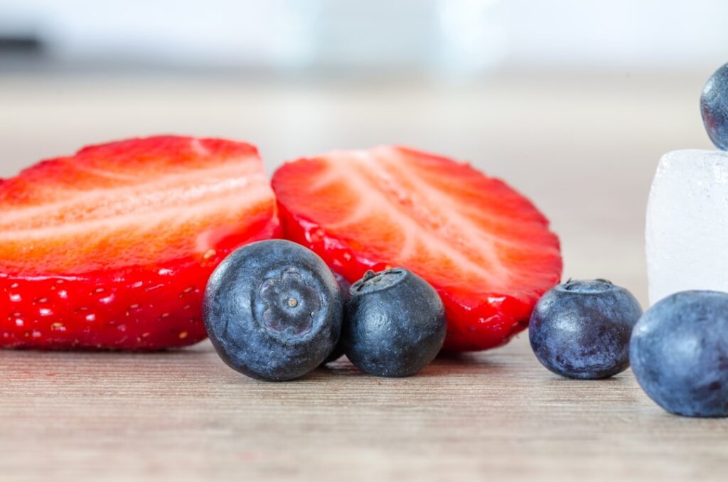 A bowl of creamy cottage cheese topped with a colorful assortment of fresh berries strawberries blueberries raspberries 