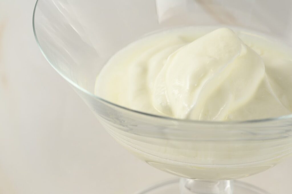 Close-up of a small glass jar containing the freshly mixed homemade Boroline cream blend showing its smooth texture