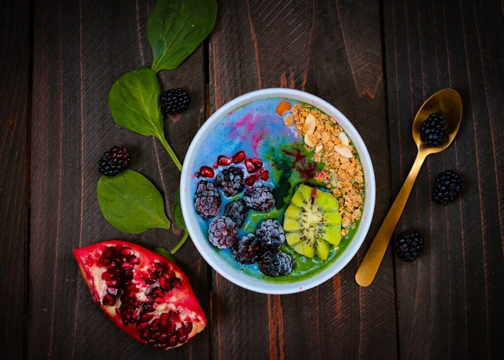 A vibrant bowl of colorful overnight oats topped with fresh berries sliced kiwi and chia seeds in a bright natural light