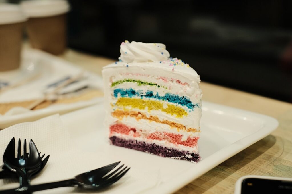 A slice of Ube Cake with its distinct purple color fluffy texture and creamy ube frosting presented on a plate