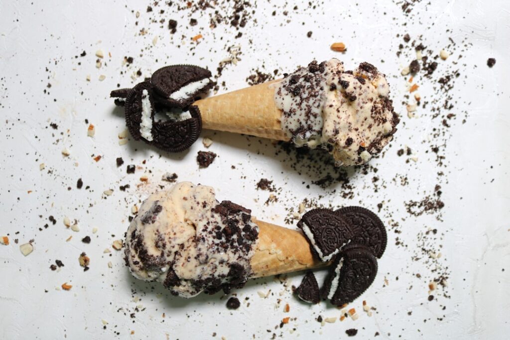 Close-up of Cookies Cream Ice Candy in a clear plastic bag with crushed Oreo cookies and whole cookies around it Playful