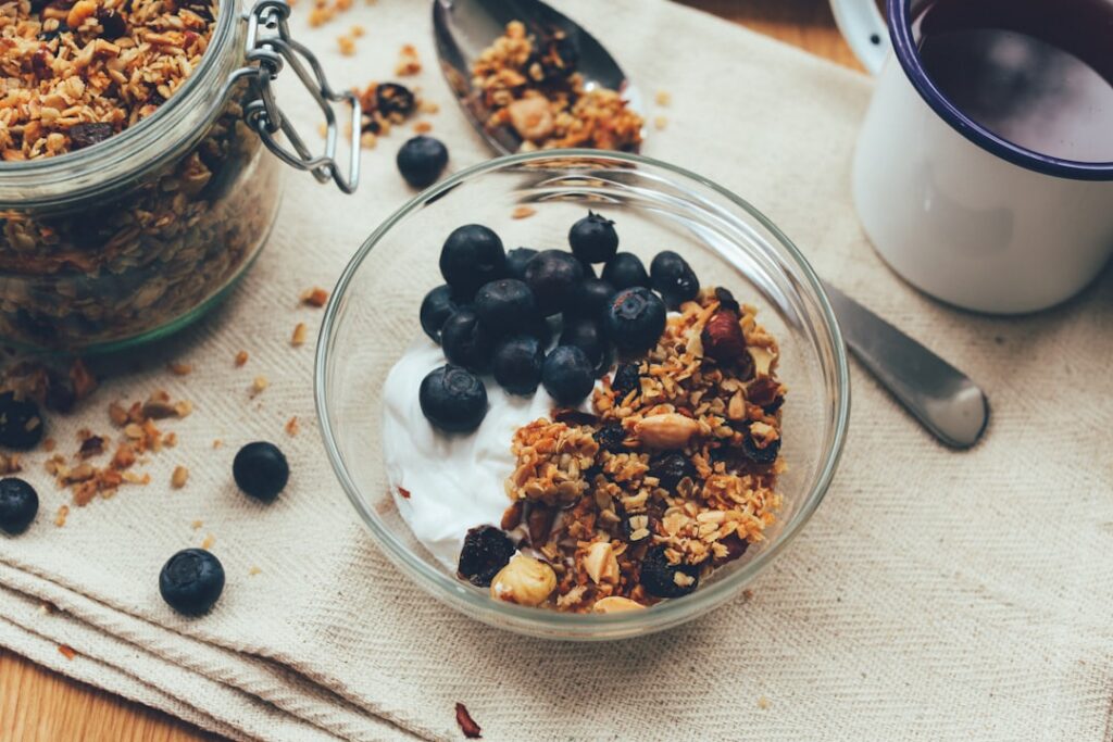 A beautiful bowl of creamy yogurt topped with colorful fresh fruits and crunchy granola ready for breakfast