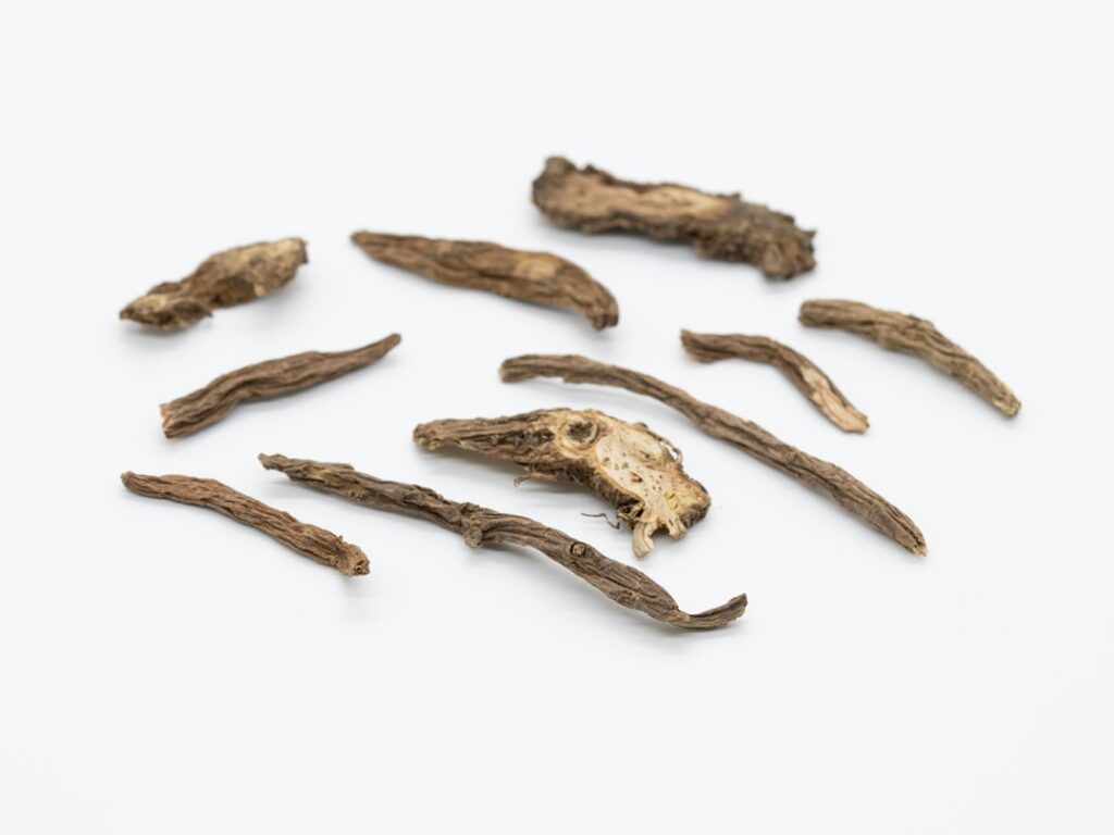 Close-up of dried dandelion root in a small bowl or on a wooden surface