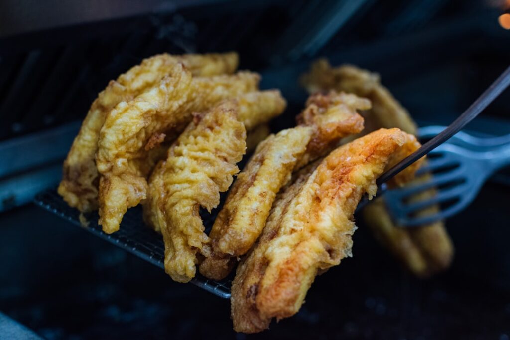 A perfectly battered and fried vegan fish fillet made from banana blossom or tofu served with crispy golden fries a doll
