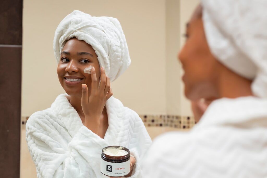 A woman in her 40s or 50s with radiant smooth and glowing skin smiling confidently