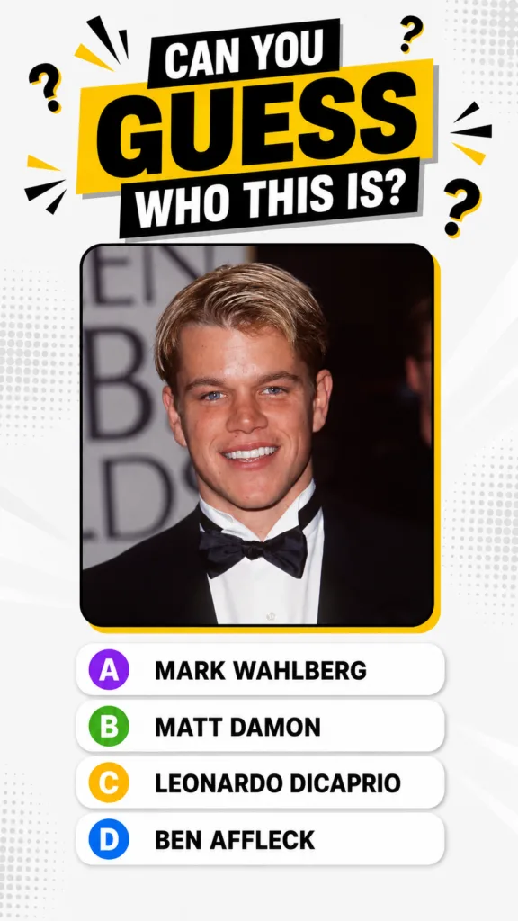 Young Matt Damon in a black tuxedo at an awards event smiling at the camera The background is blurred with hints of Gold