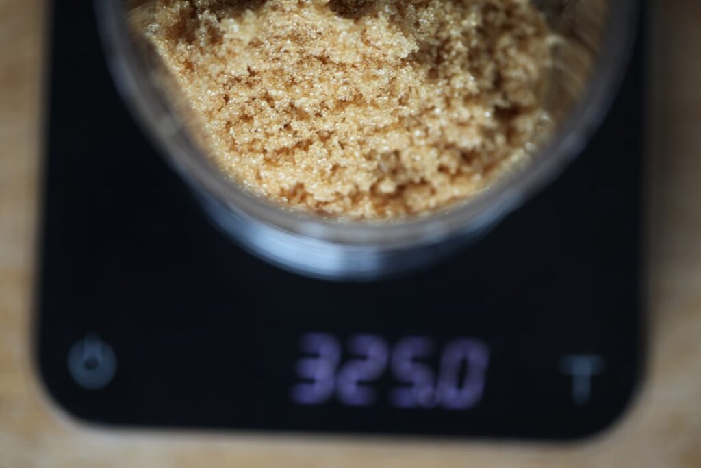 A clear glass of Brown Sugar Shaken Espresso with ice showing the layers of espresso brown sugar syrup and a splash of m