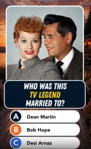 A colorized classic portrait of Lucille Ball and Desi Arnaz Lucille Ball has red hair and red lipstick wearing a houndst