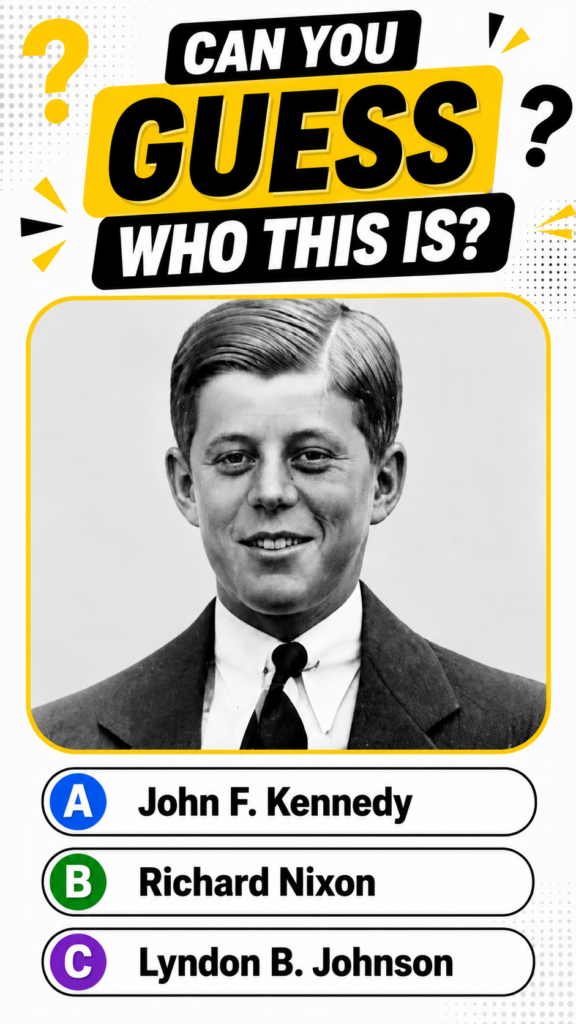 A black and white portrait of a young John F Kennedy in a suit looking confident