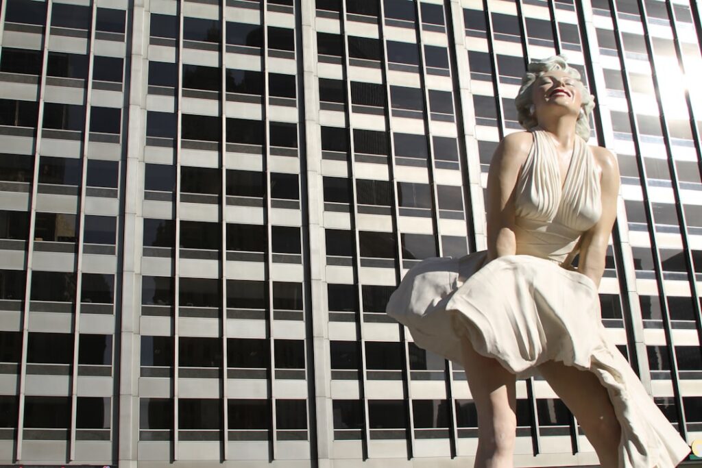 Marilyn Monroe striking a classic pose perhaps from The Seven Year Itch with her white dress flowing up capturing her ic