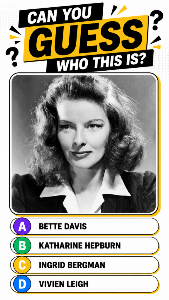 A black and white portrait of a young Katharine Hepburn with soft wavy hair wearing a dark top with a white collared shi