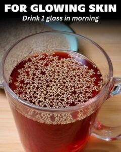 A close-up of a glass of warm water with lemon slices a spoon of honey and fresh ginger glowing softly in morning light