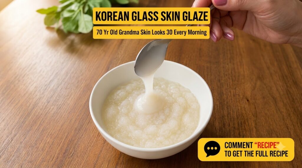 A close-up of a white ceramic bowl filled with a creamy textured rice paste A hand holds a silver spoon from which a thi