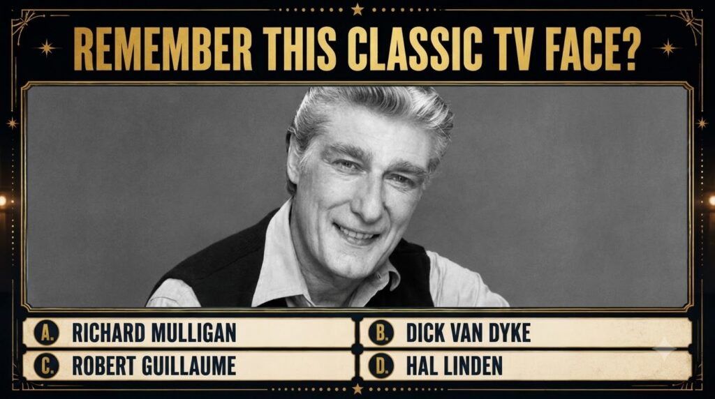 Black and white portrait of a smiling man with grey hair in a decorative gold frame as seen in a classic TV face quiz