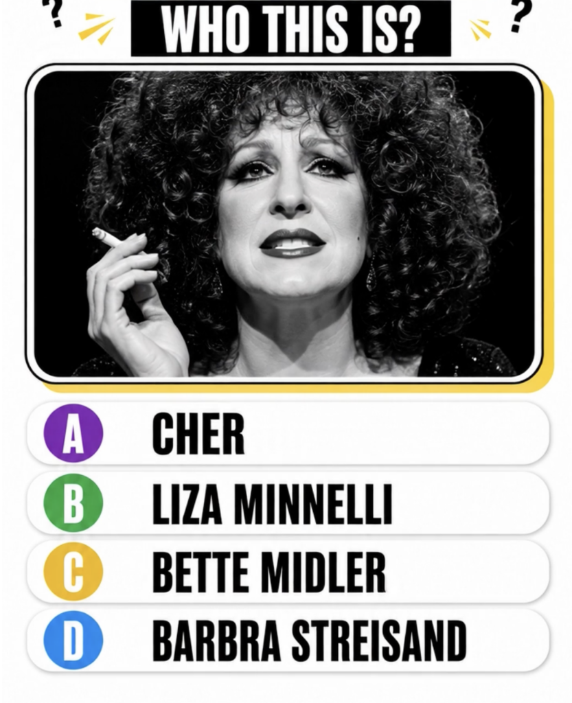 Black and white portrait of a younger Bette Midler with voluminous curly dark hair dramatic eye makeup and dark lipstick