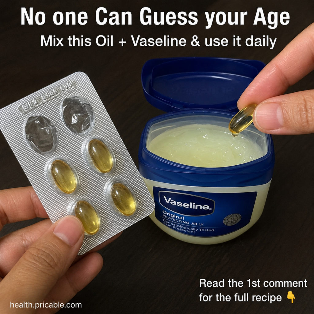 Hands mixing Vaseline from a classic blue and white jar with oil from a golden Vitamin E capsule on a dark surface