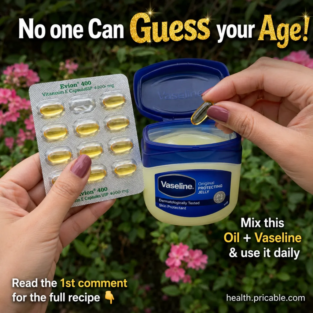 A close-up of hands mixing Vitamin E capsules with Vaseline petroleum jelly in a small jar with lush green foliage in th