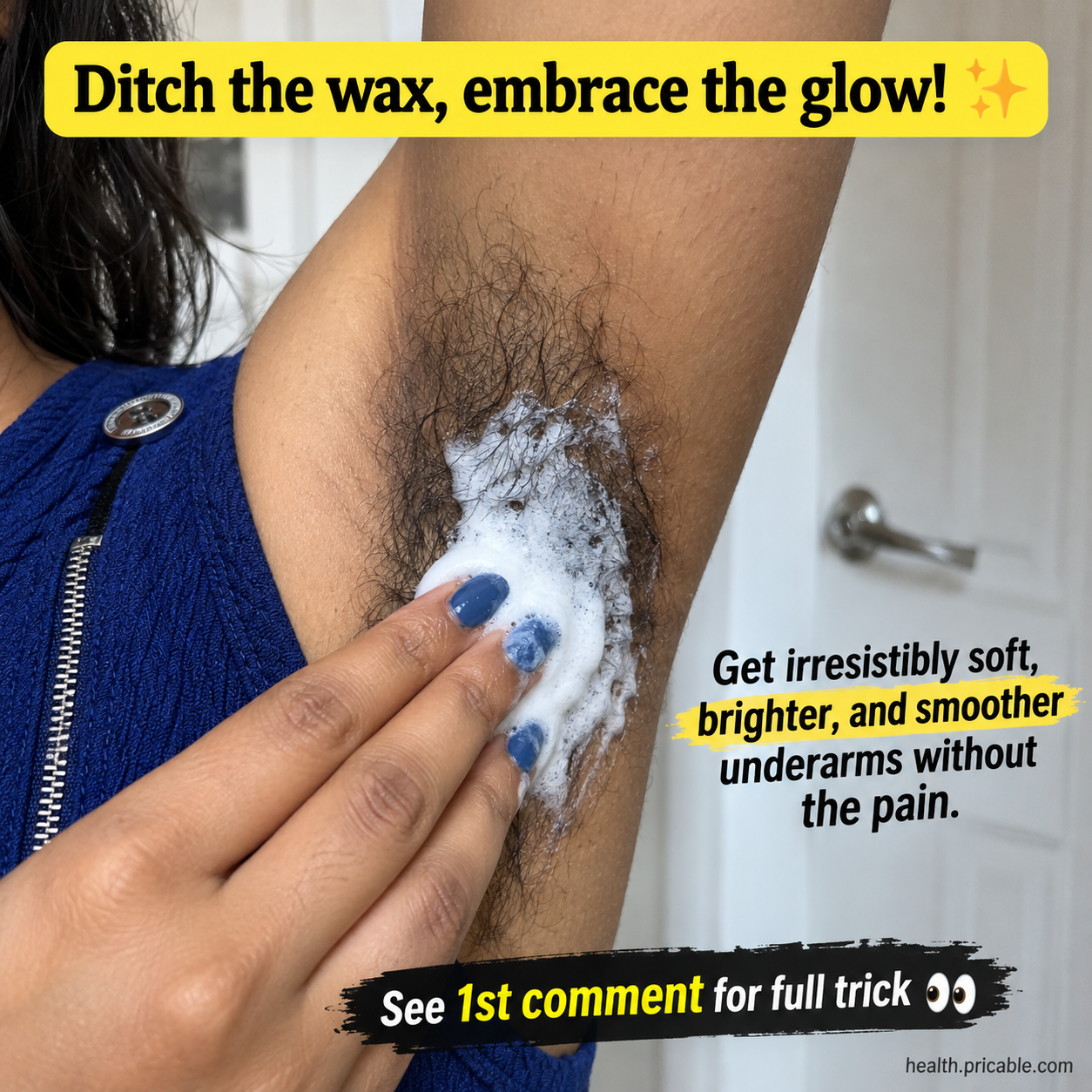 A close-up of a hand applying a white foamy paste to an underarm with visible hair in a bathroom setting