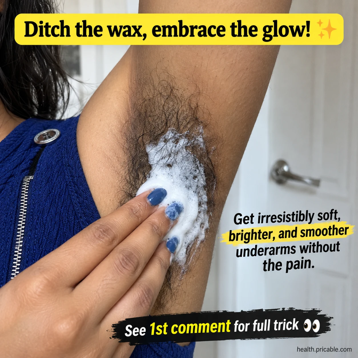 A close-up of a hand applying a white foamy paste to an underarm with visible hair in a bathroom setting