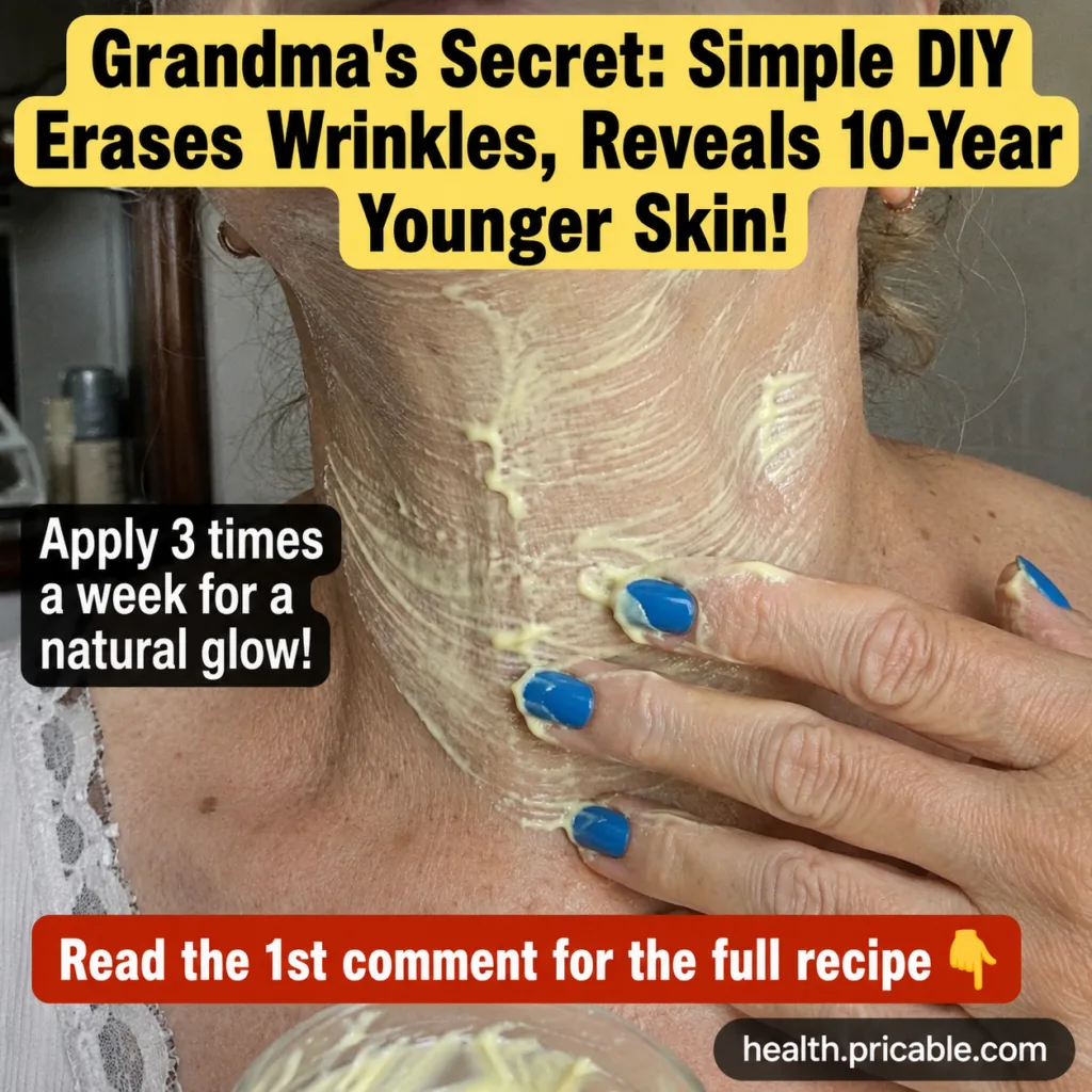 A person s hand with blue nail polish applies a thick light yellow creamy mask to their neck which shows some fine lines