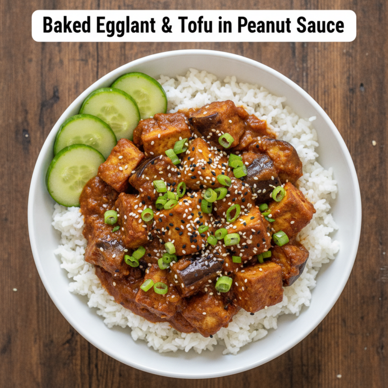 An overhead shot of Baked Eggplant Tofu in Peanut Sauce served over white rice on a rustic wooden surface garnished with