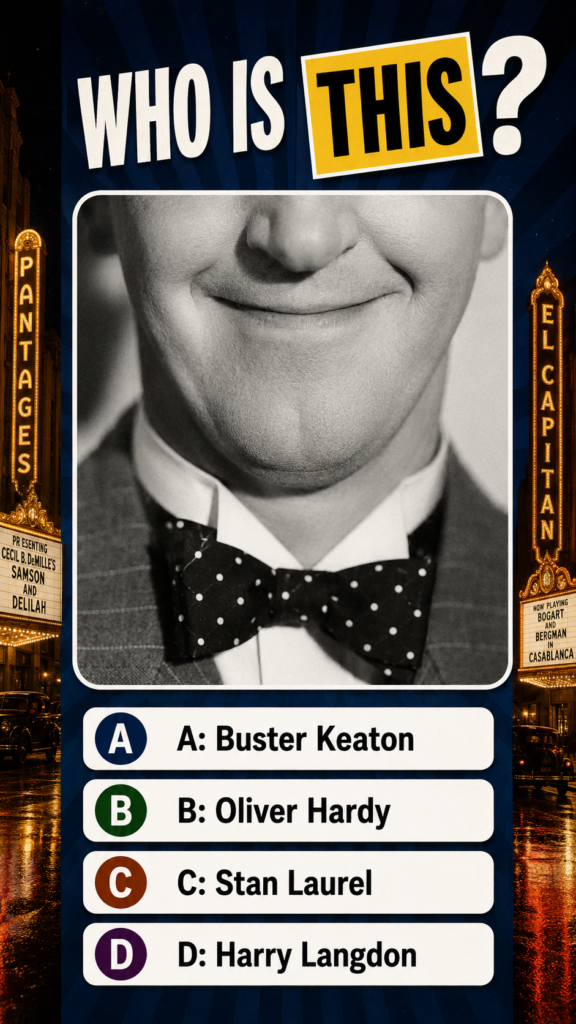 A close-up black and white portrait of a man s smiling mouth and chin wearing a suit and polka-dotted bow tie The quiz q