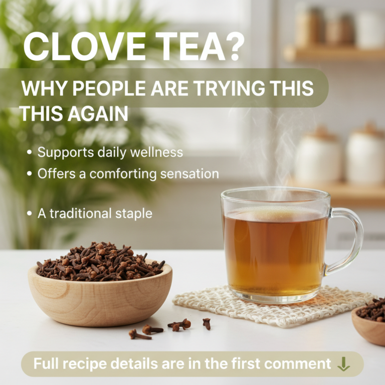 A steaming glass mug of amber clove tea on a white crocheted coaster with dried cloves in a wooden bowl and scattered on
