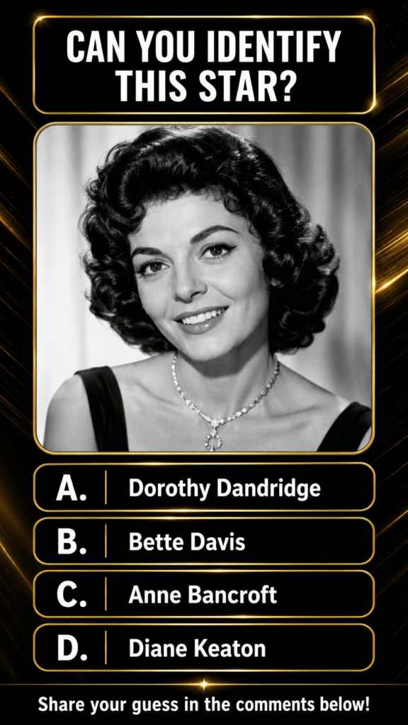 A black and white portrait of Anne Bancroft smiling with dark curly hair and a sparkling necklace framed in a gold borde