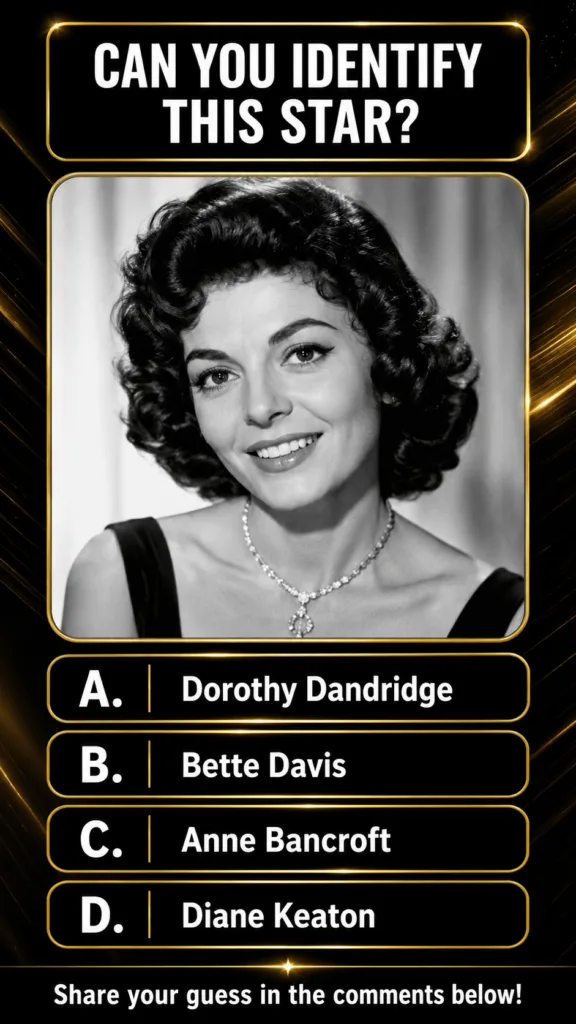 A black and white portrait of Anne Bancroft smiling with dark curly hair and a sparkling necklace framed in a gold borde