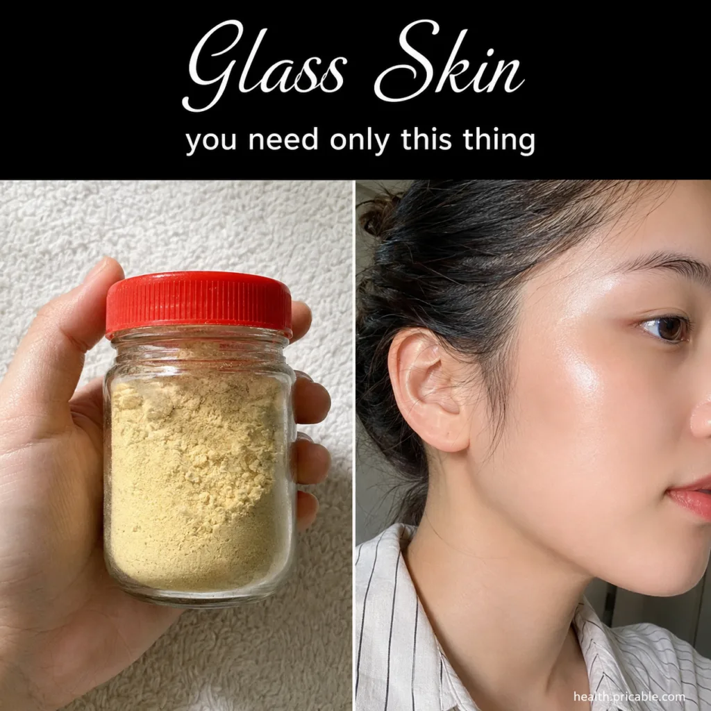 A hand holding a small clear glass jar with a vibrant red lid filled with light yellow finely ground powder against a so