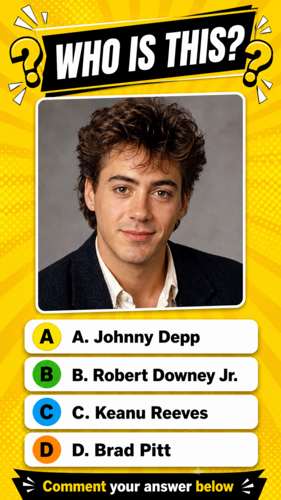 A portrait of a young Robert Downey Jr from his early career with curly brown hair light brown eyes and a slight smile H