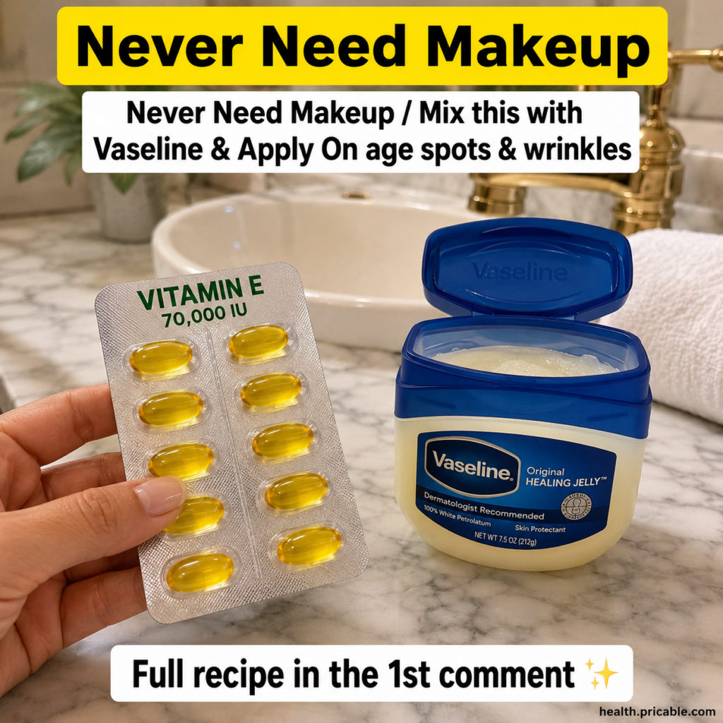 Blister pack of golden Vitamin E capsules and an open jar of Vaseline Original Healing Jelly on a marble counter in a cl