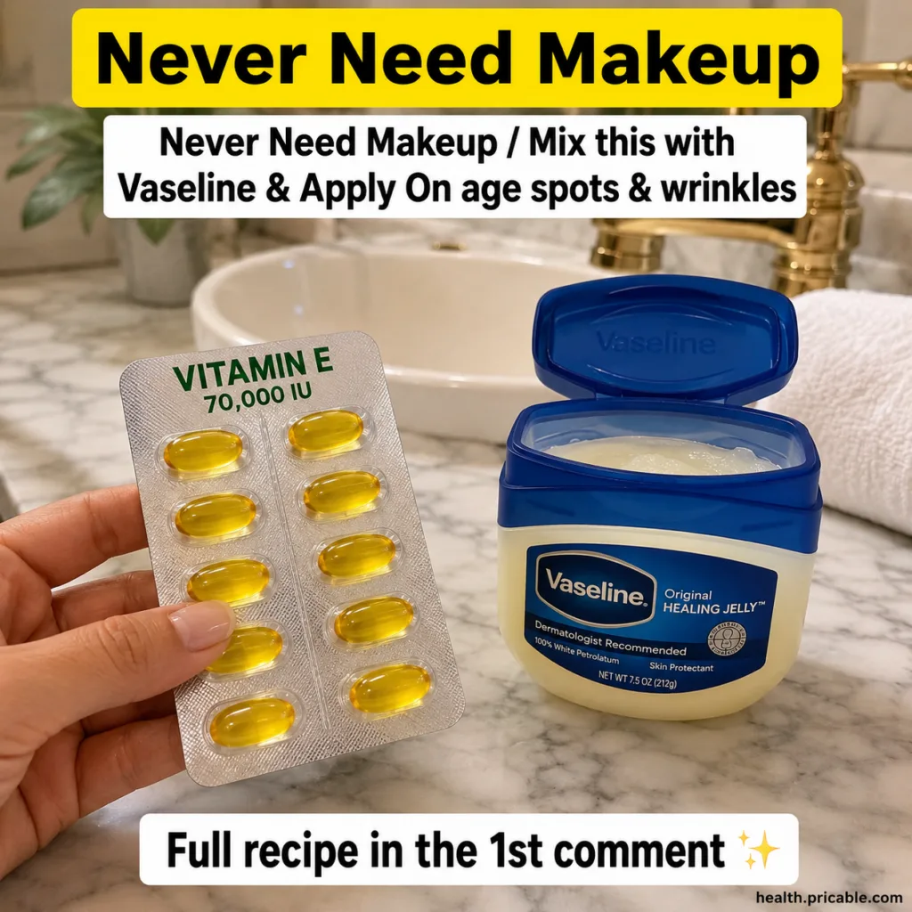 Blister pack of golden Vitamin E capsules and an open jar of Vaseline Original Healing Jelly on a marble counter in a cl