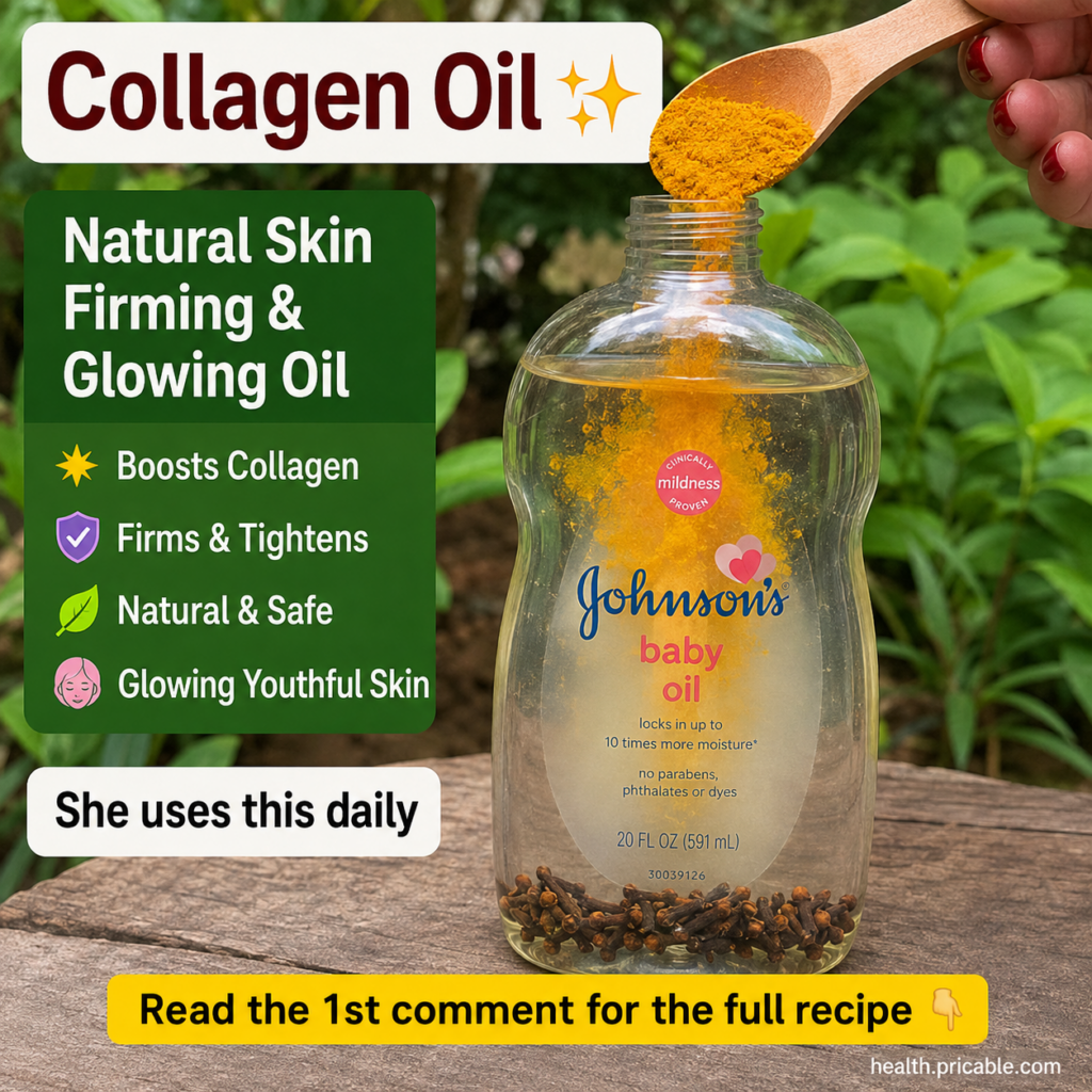 A hand with red polished nails pouring yellow turmeric powder into a clear bottle of baby oil containing submerged clove
